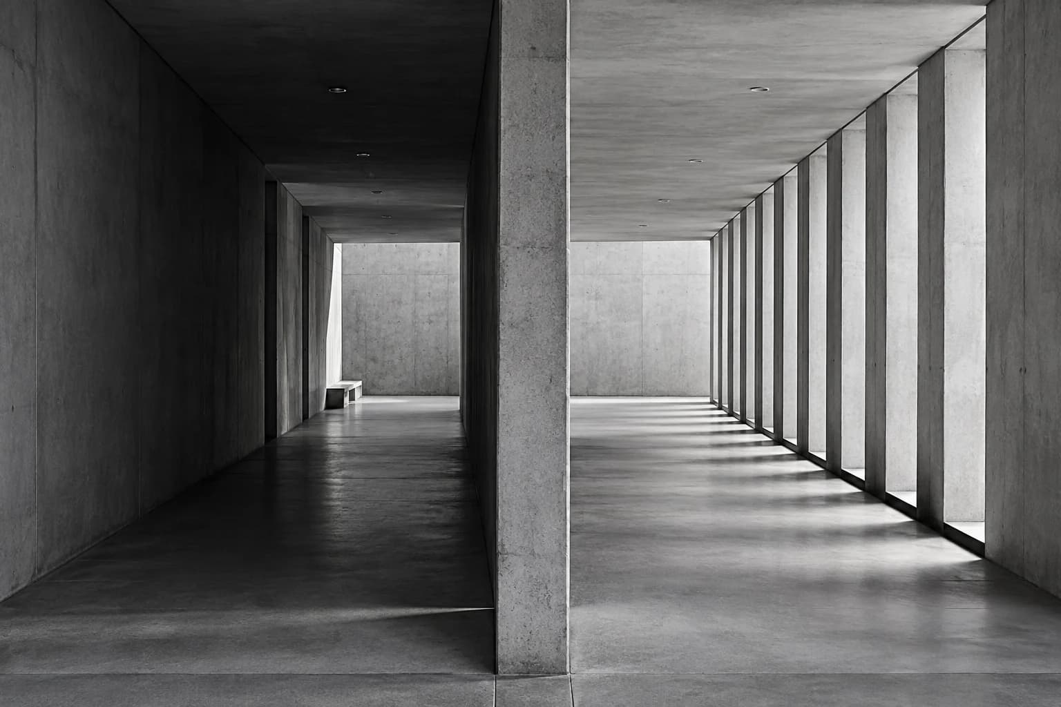 Monochrome photograph of two parallel architectural passageways